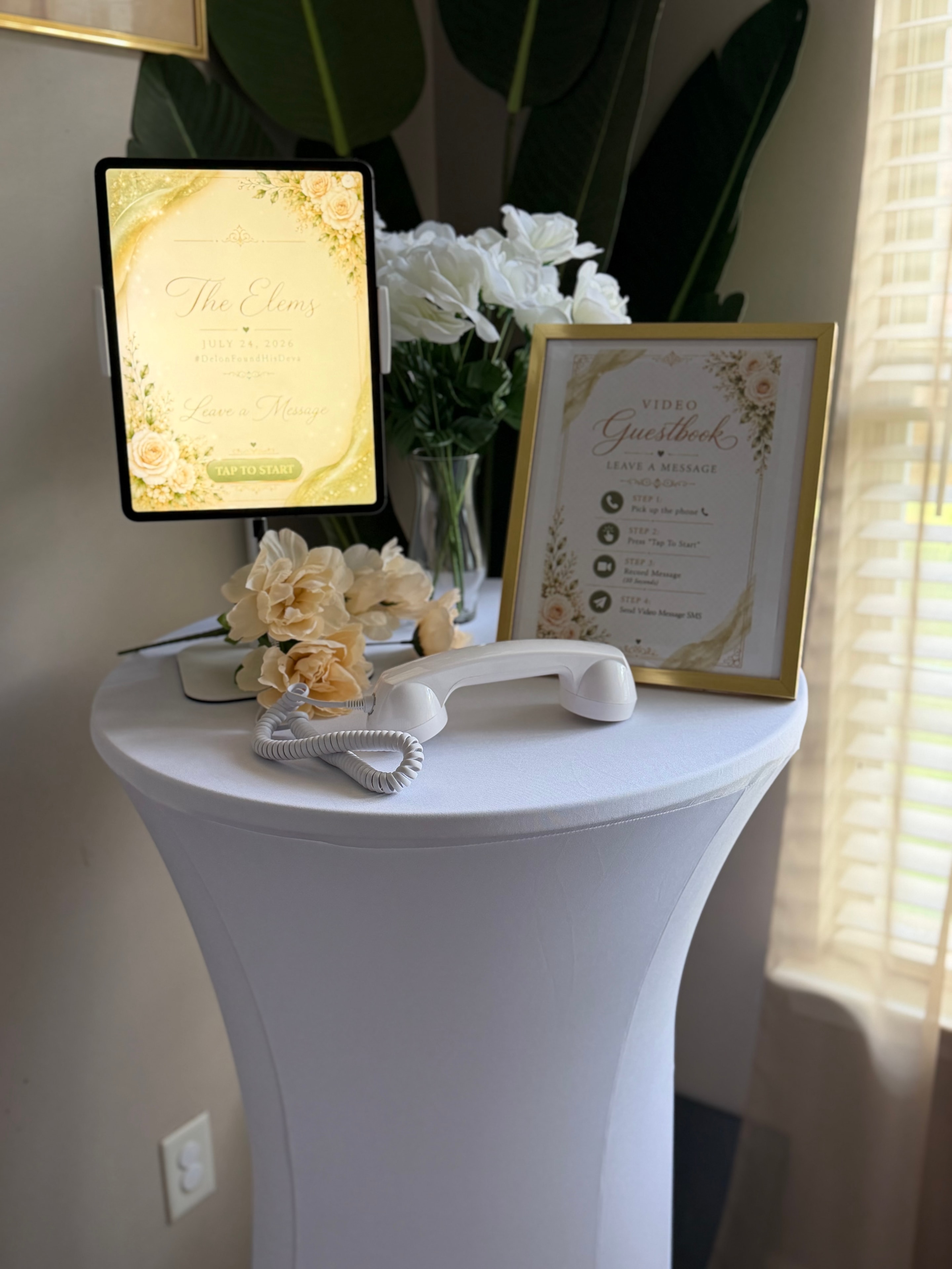 The Elems wedding video guestbook station with flowers